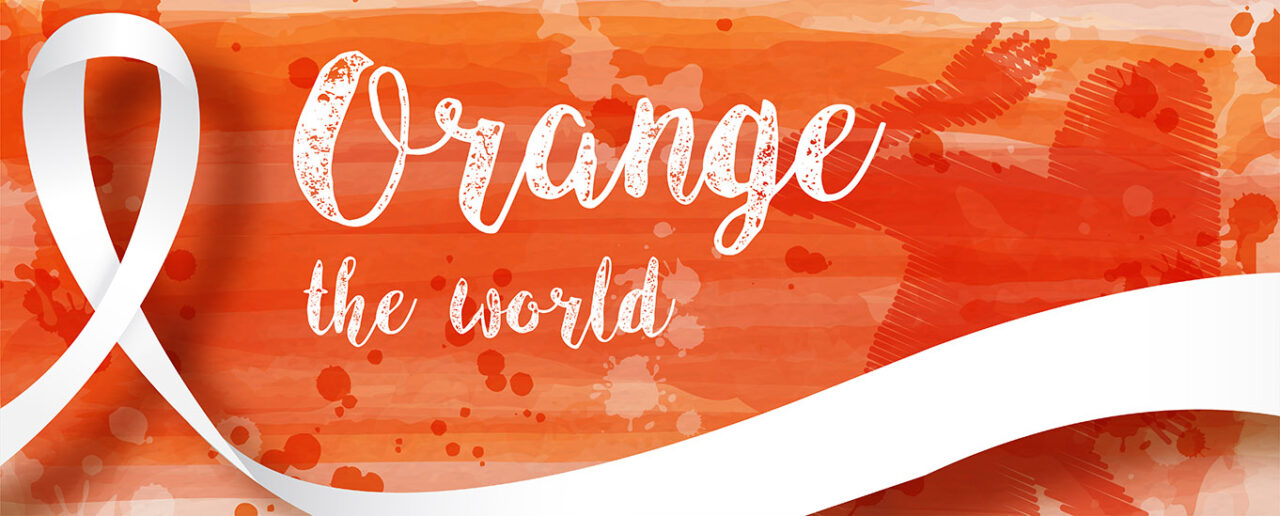 Schriftzug Orange the World auf orangenem Hintergrund